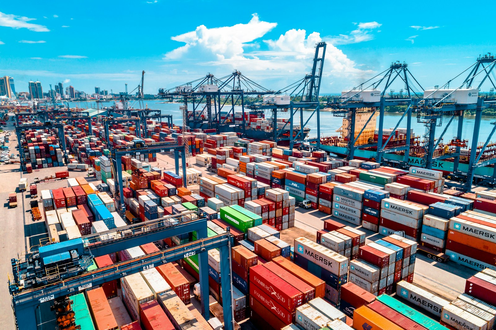 Container terminal with cranes and stacked containers at a busy port